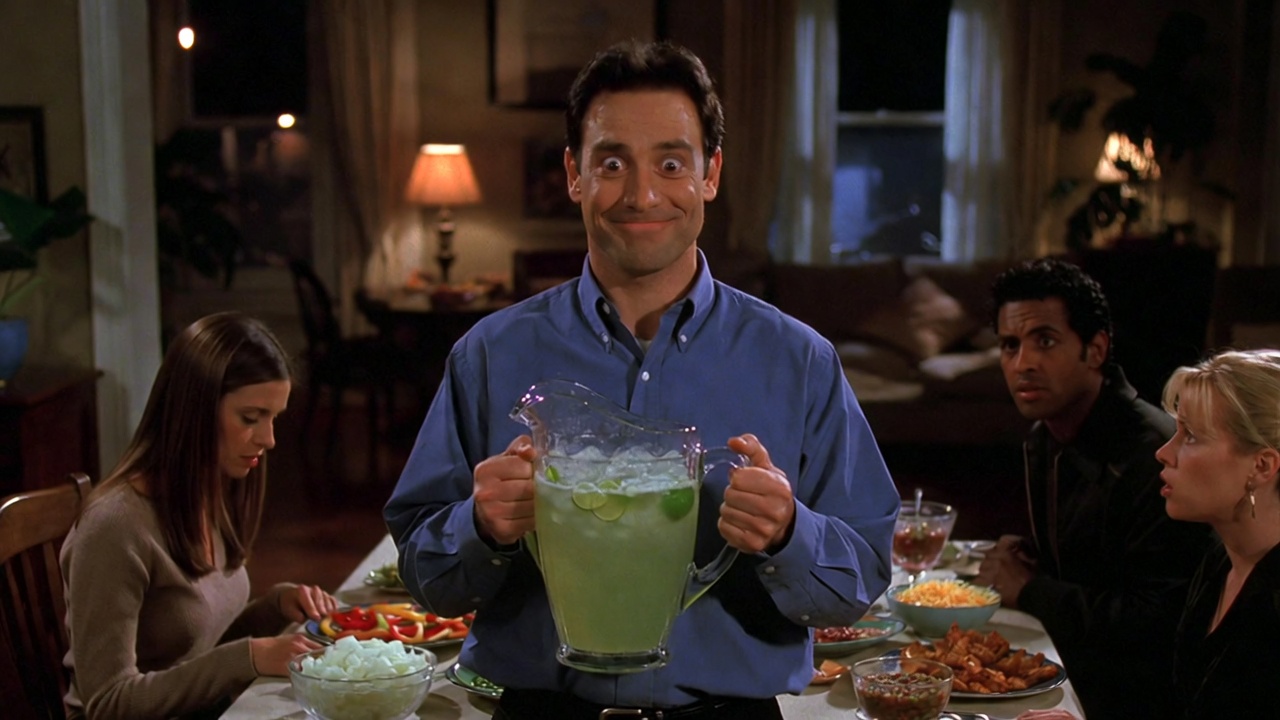 Ross holding margarita pitcher during the awkward dinner party scene in Friends Season 10 