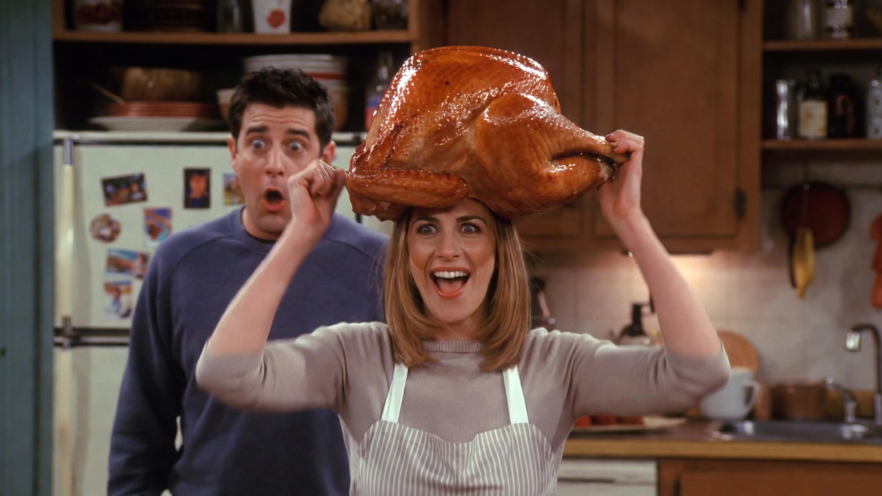 Monica with turkey on her head dancing to cheer Chandler in Friends Thanksgiving episode, classic hilarious Mondler moment