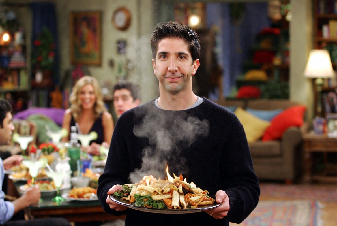 Ross Geller awkwardly holding hot fajita platter during the I'm fine dinner scene in Friends